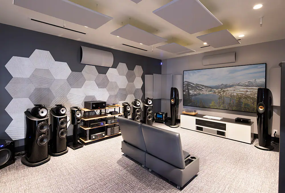 Modern acoustically treated home theater room with a large projection screen